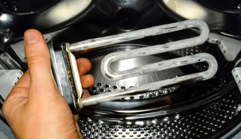 Limescale deposits on the heating element of a washing machine. Lime could be a raw material for calcium batteries in the future.