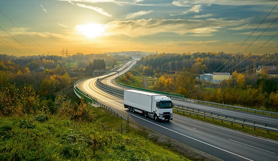 Truck driving through natural landscape. Symbolic image for the disposal of batteries and accumulators.